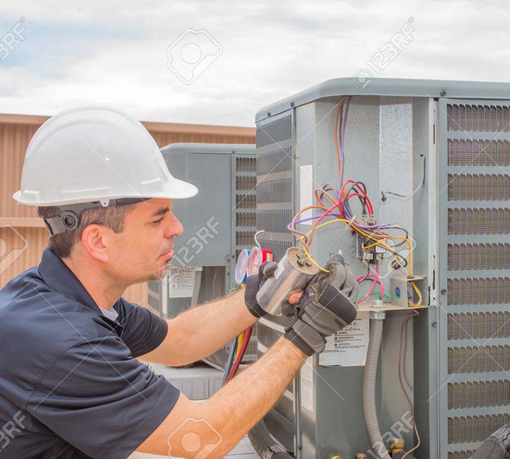 Man working on HVAC Compressor